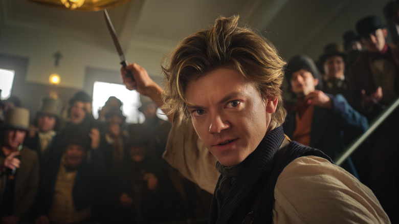 Jack Dawkins holds knife up