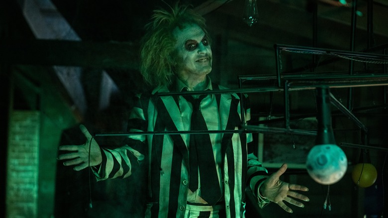 Beetlejuice smiling with hands out